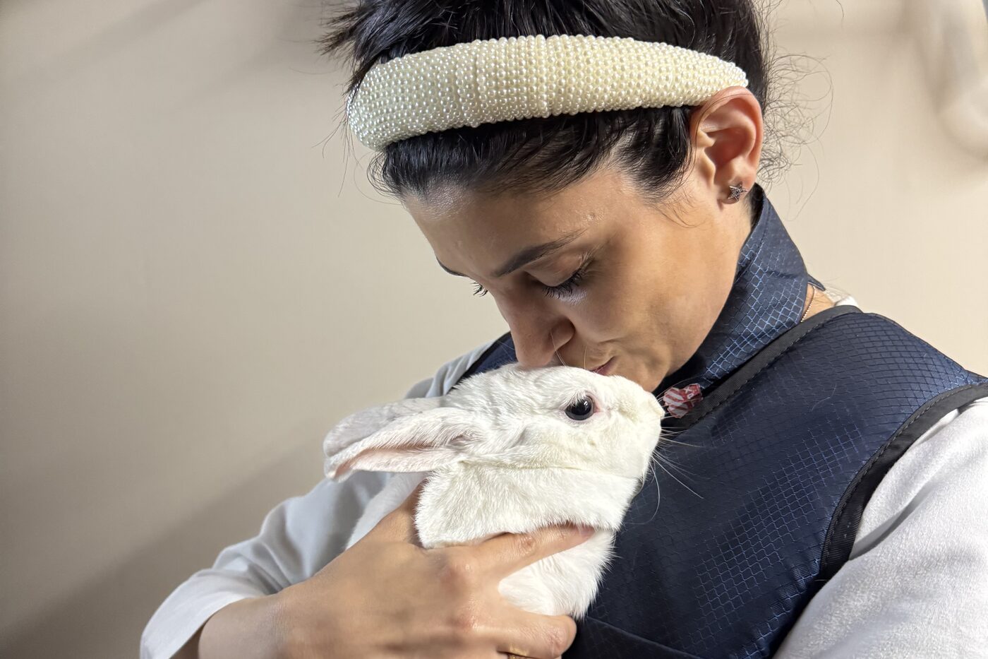 Dr. Zonenshine cradling a rabbit during a wellness visit